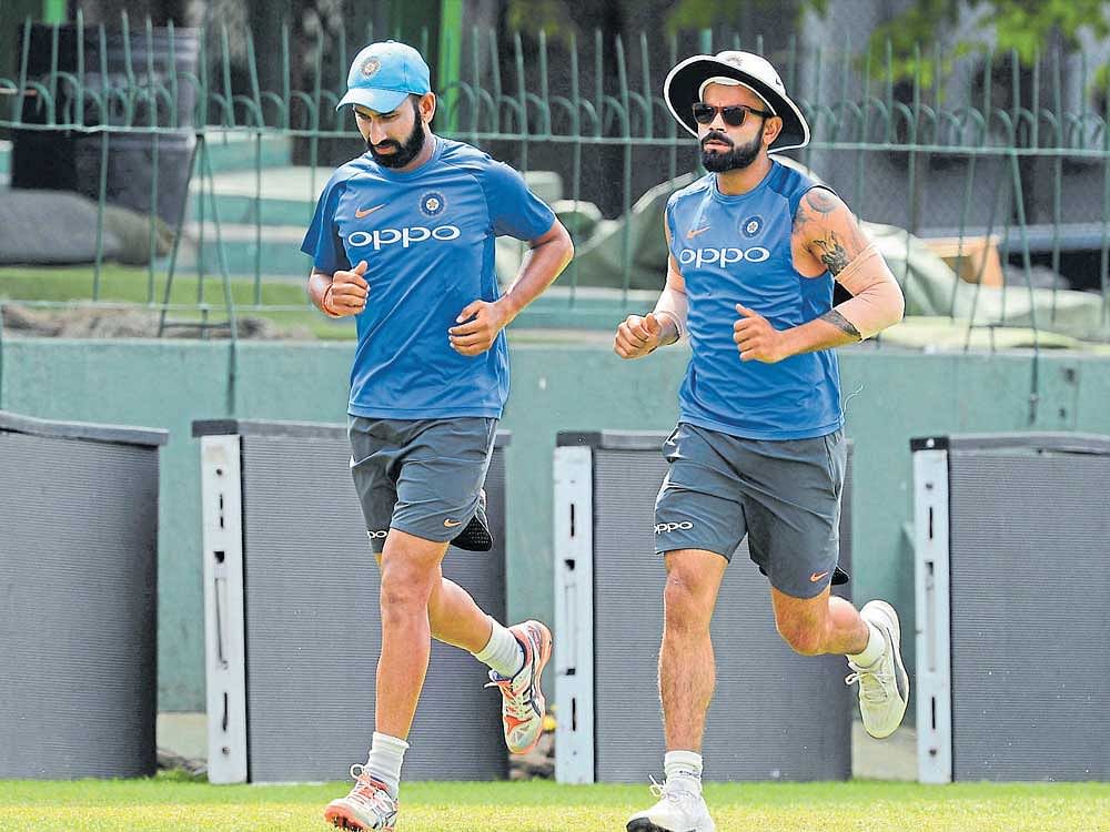 India's Virat Kohli (right) and Cheteshwar Pujara, centurions in the first Test, will look to maintain their good form in the second game. AFP