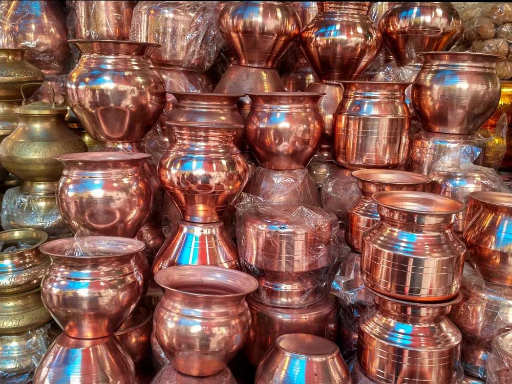 Lots of copper water vessel at stall market