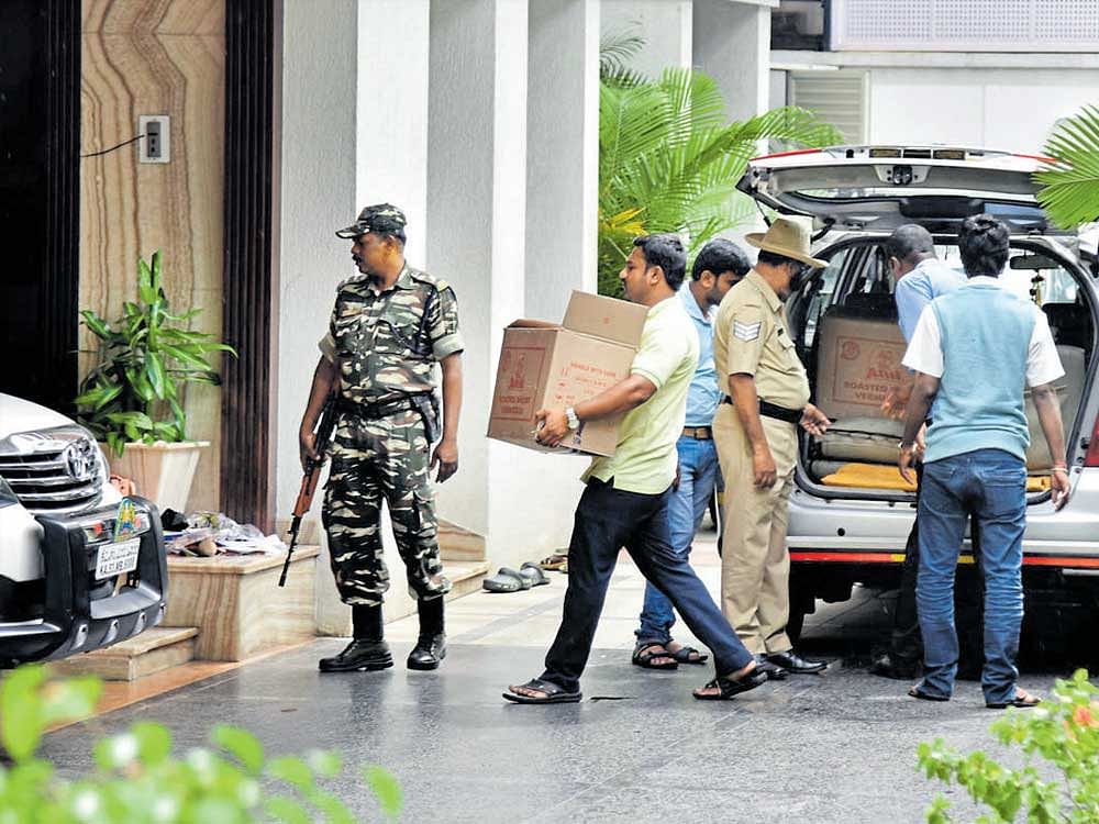 Staff carry food for the I-T officials, who have been camping at Energy Minister D K Shivakumar's house in Sadashivanagar in Bengaluru as part of the search operations, on Friday. dh photo