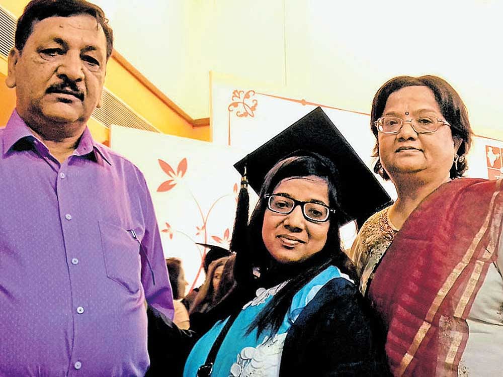 Tarang Jain with her parents Dr J P Jain and Dr Alaka during the 25th convocation of NLSIU in the city on Sunday. DH PHOTO