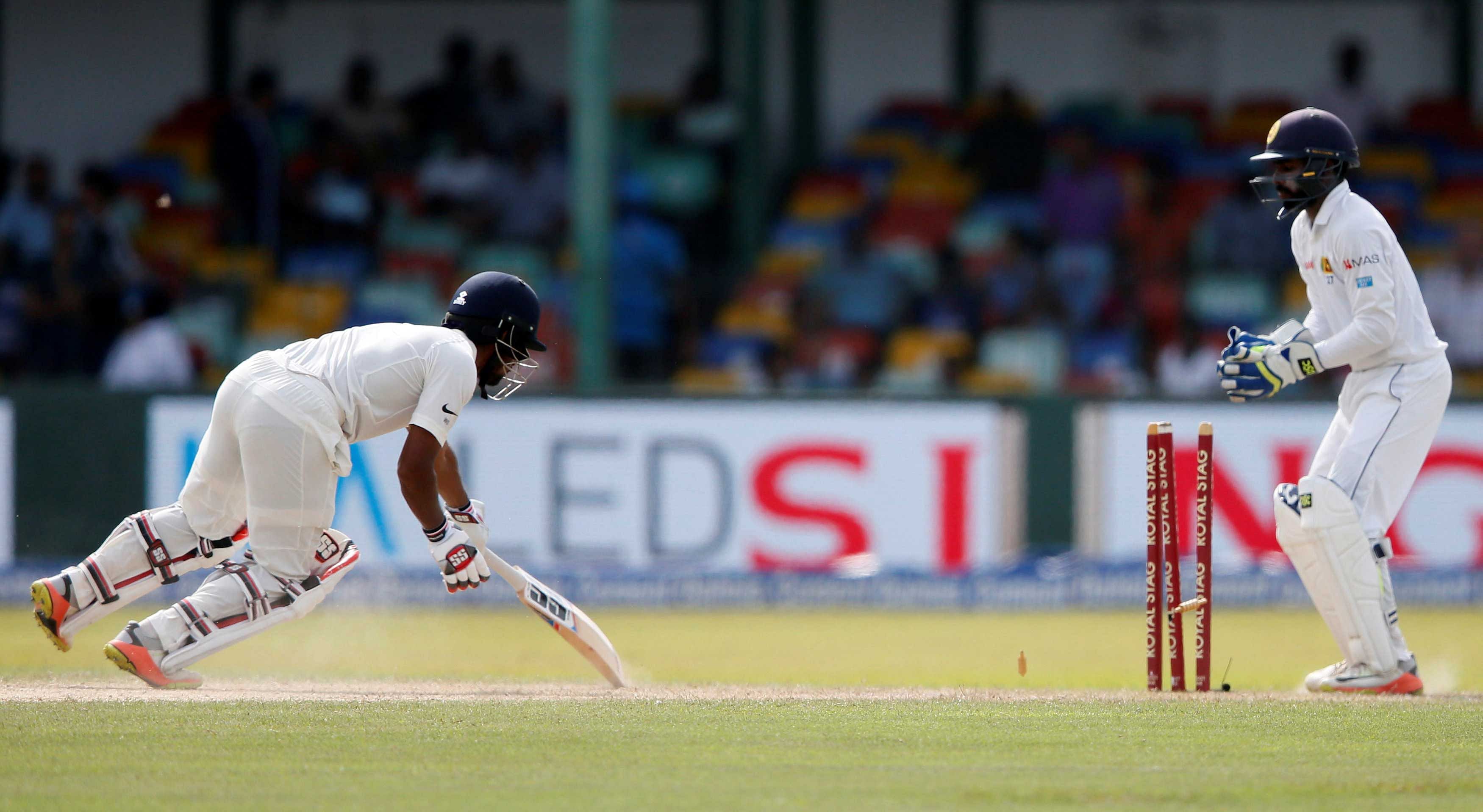 India's Wriddhiman Saha is stumped out by Sri Lanka's wicketkeeper Niroshan Dickwella. REUTERS