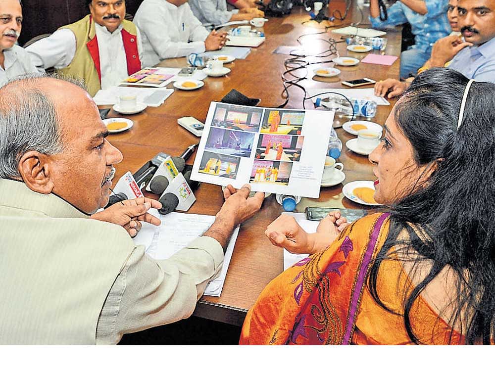 Kannada Development Authority Chairman S G Siddaramaiah (left) interacts with Tourism Department director N Manjula during a meeting in Bengaluru on Tuesday. DH&#8200;Photo