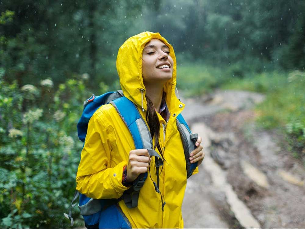 Young woman enjoying rainy weather.