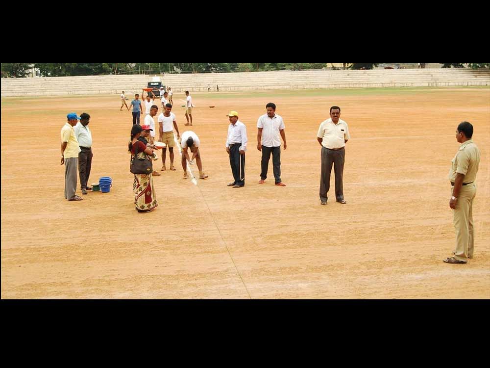 Workers make preparations for the Independence Day celebrations at Sir M Visvesvaraya Stadium, in Mandya on Monday.