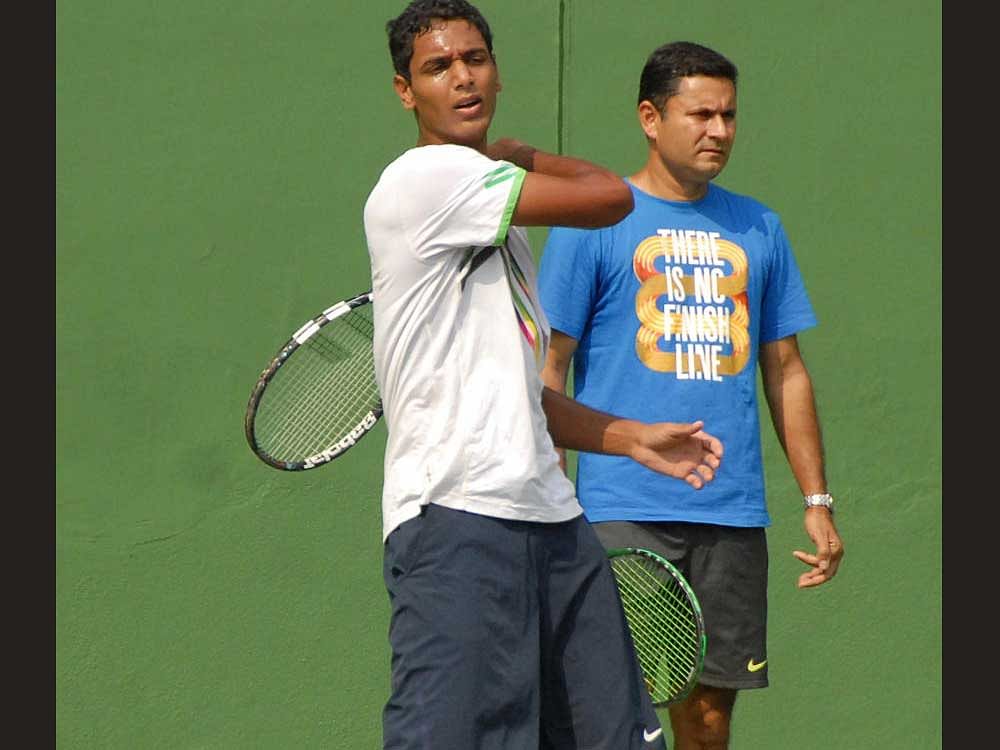 Ramkumar practicing at KSLTA for the Davis cup in Bangalore on Sunday. Zeeshan Ali, All India Tennis coach also seen DH photo