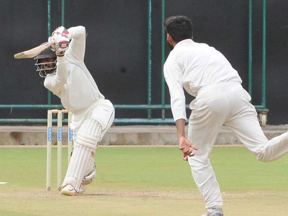 FETCH THAT! Andhra's K S Bharath drives one to the boundary during his knock of 54 against Gujarat at the Chinnaswamy Stadium on Wednesday. DH PHOTO