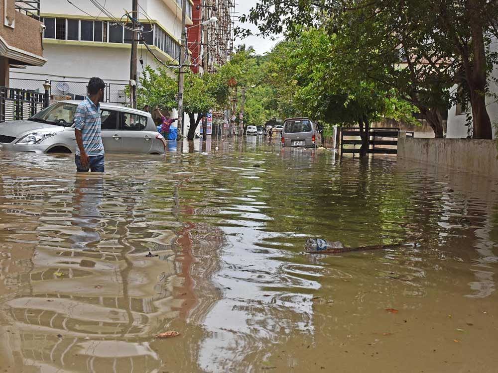 Areas near the BMTC bus depot in Koramangala saw heavy waterlogging. Bus drivers said they had tried to pump out the stagnant water. Representational Photo. DH Photo.