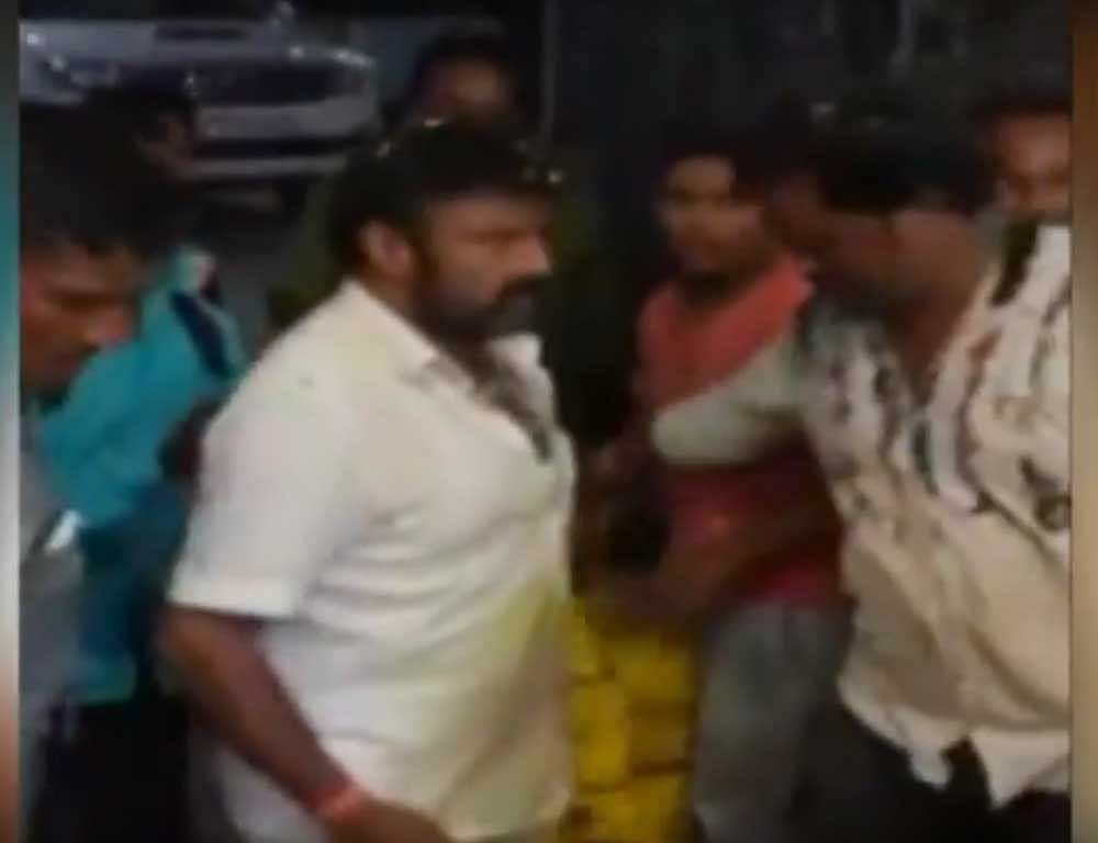 The video shows Nandamuri Balakrishna slapping a fan who fell on him. ANI video.