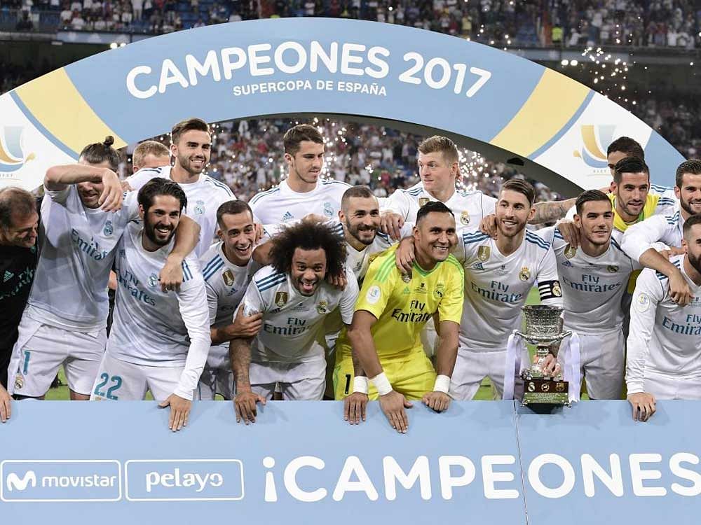Real Madrid players celebrate after winning the Spanish Super Cup on Wednesday. They defeated Barcelona 5-1 on aggregate. AFP