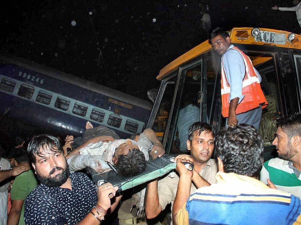 An injured passenger of Haridwar- Puri Utkal express train, which got derailed, is being rescued in Khatauli near Muzaffarnagar on Saturday. PTI Photo