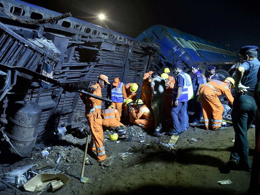 The NDRF rescue team at the mangled coaches of the Puri-Haridwar Utkal Express train after it derailed in Khatauli near Muzaffarnagar on Saturday. PTI Photo