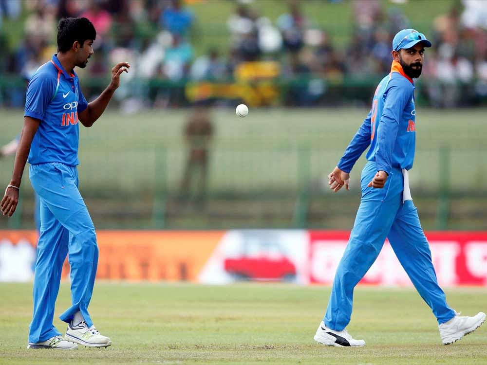 Sri Lanka v India - Second One Day International Match - Pallekele, Sri Lanka - August 24, 2017 - India's captain Virat Kohli passes the ball to Jasprit Bumrah.REUTERS