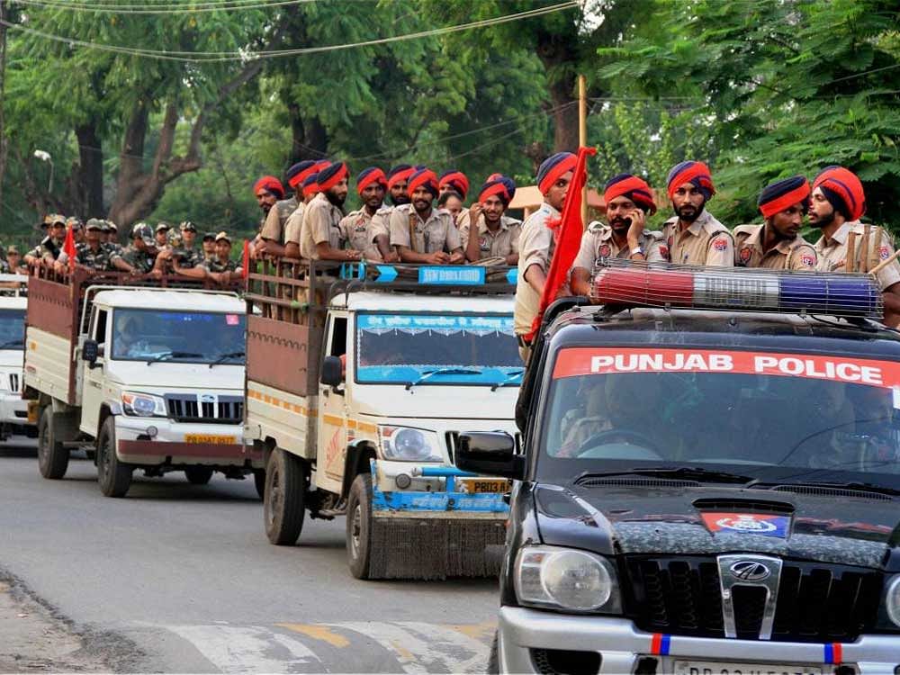 Personnel of Punjab police and paramilitary forces take out a flag march in a sensitive area of Bathinda on Tuesday in view of verdict on Dera Sacha Sauda head Gurmeet Ram Rahim Singh on Thursday. PTI