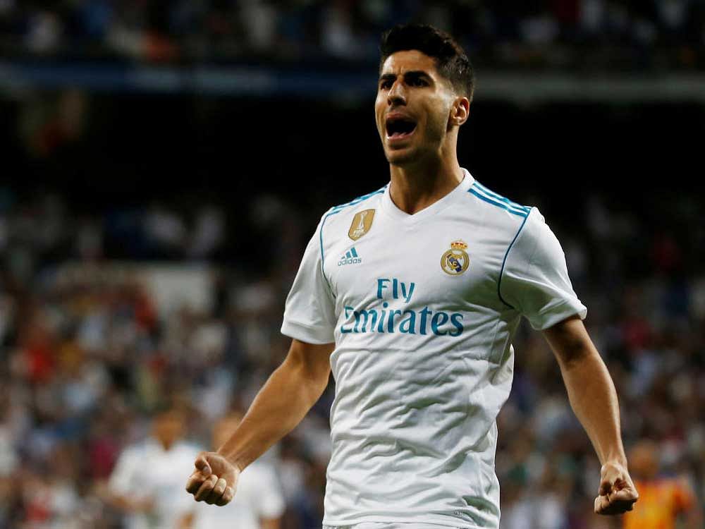 Real Madrid's Marco Asensio celebrates after scoring against Valencia. AFP
