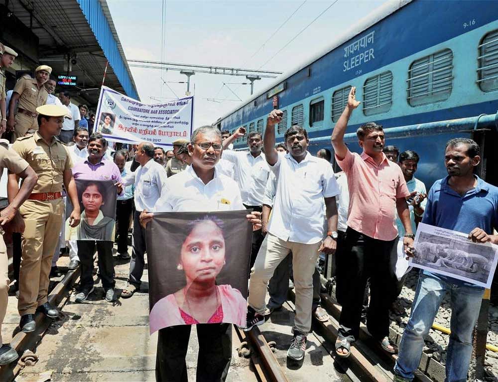 Members of Coimbatore Bar Association raise slogans during a 'Rail Roko' protest against NEET Exams and demanding justice for student Anitha's death, in Coimbatore on Friday. PTI Photo