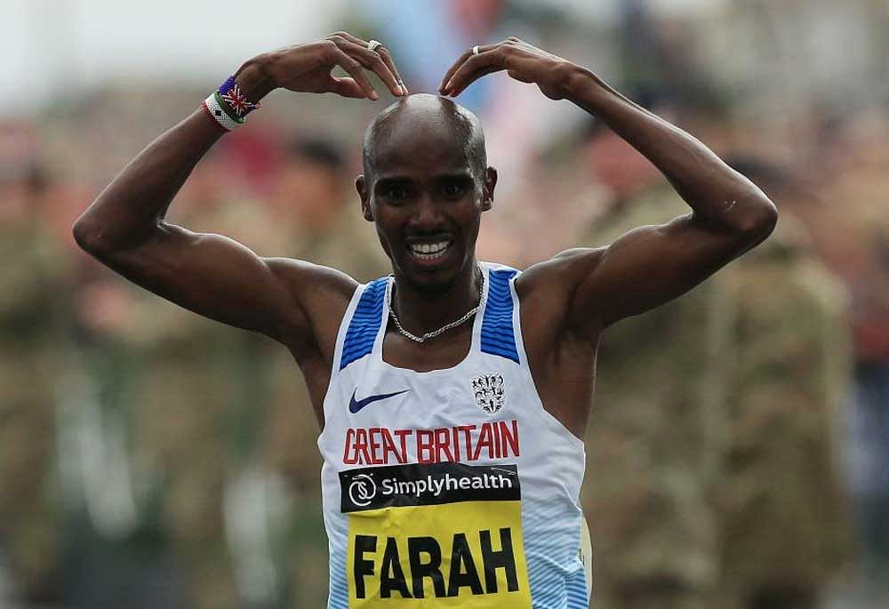 Another win: Britain's Mo Farah does his trademark Mobot gestures as he approaches the finish line to win the Great North Run. AFP
