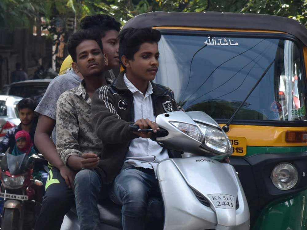 Young people are often seen flouting rules and doing stunts on the roads. DH Photo by S K Dinesh