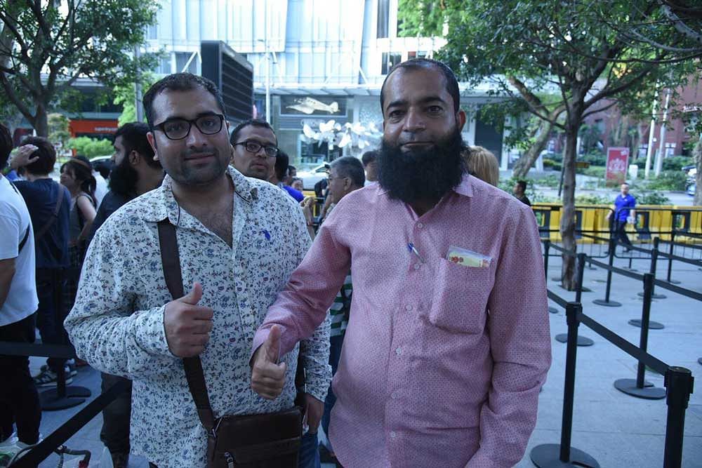 Amin Ahmed Dholiya (R) was first in line to purchase 2 of the new iPhone 8. Twitter photo.