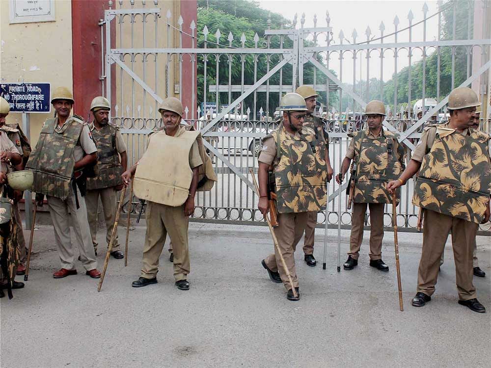 Police men deployed at Banaras Hindu University in view of the students protests, in Varanasi on Monday. PTI Photo