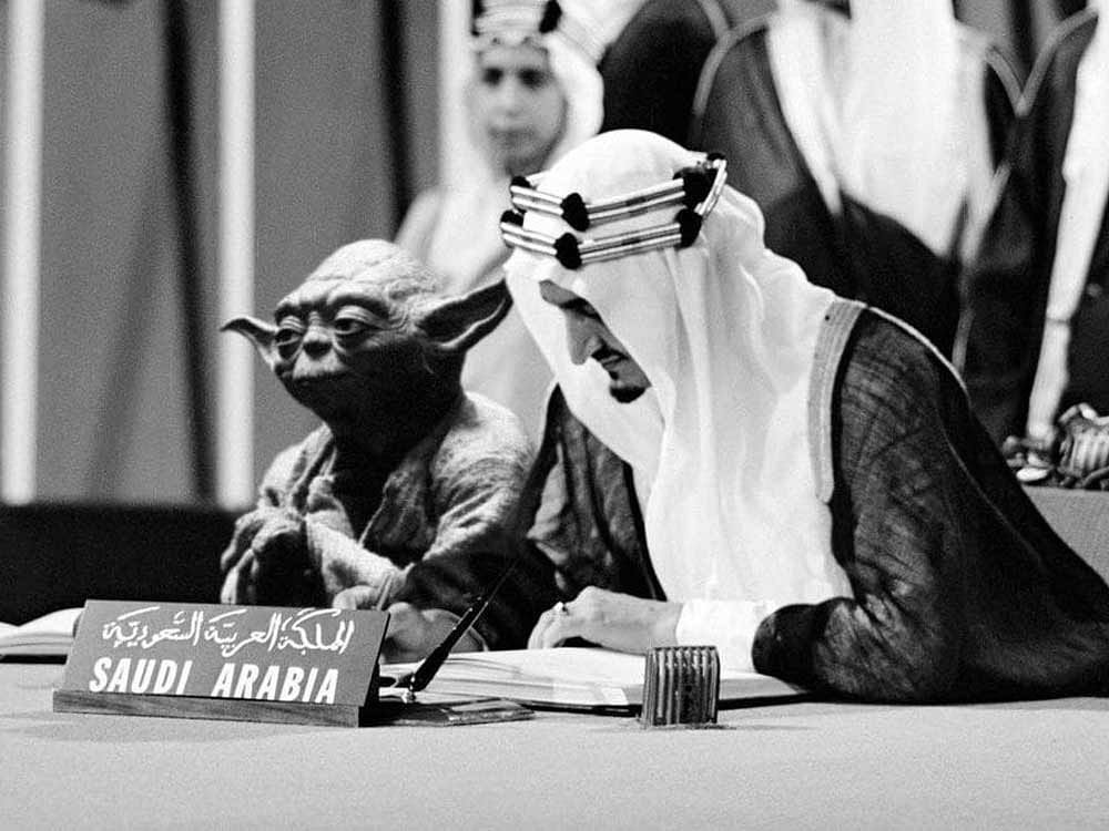 The black-and-white image shows King Faisal, Saudi Arabia's third monarch, signing the United Nations Charter in 1945, with the diminutive Jedi master Yoda perched next to him. Image Courtesy: Twitter