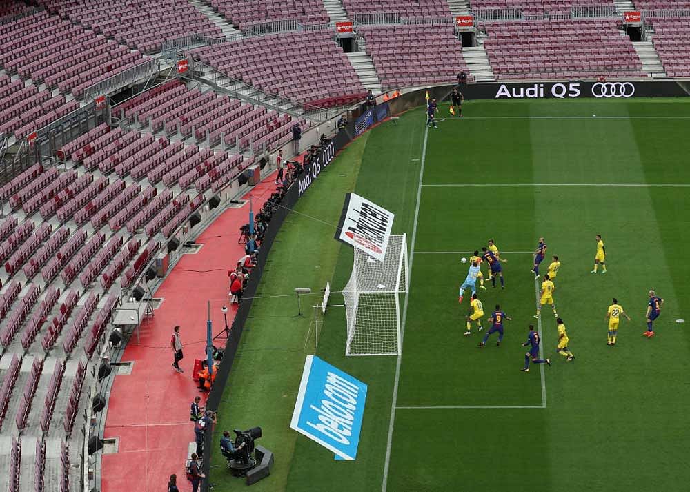 Silent protest: Barcelona play Las Palmas in their La Liga tie in front of empty stands on Sunday. Reuters