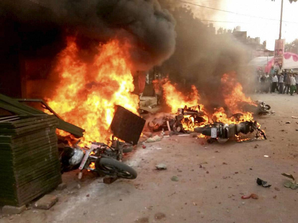 Vehicles set on fire after a clash between two communities during a Muharram procession at Parampurva in Kanpur on Sunday. PTI Photo