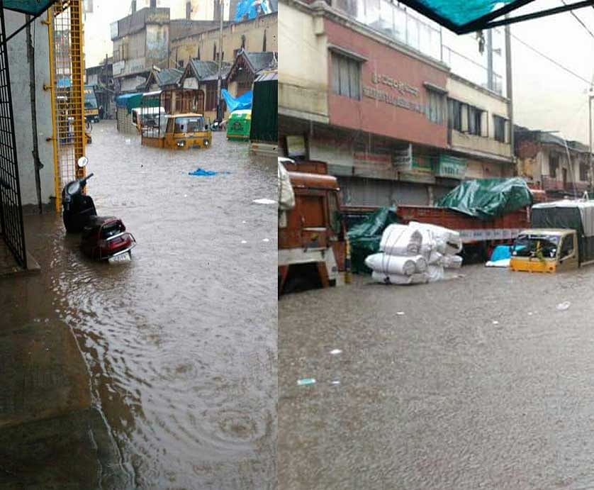 Vehicles submerged in the rainwater at Chickpet after heavy rains in Bengaluru. DH Photo