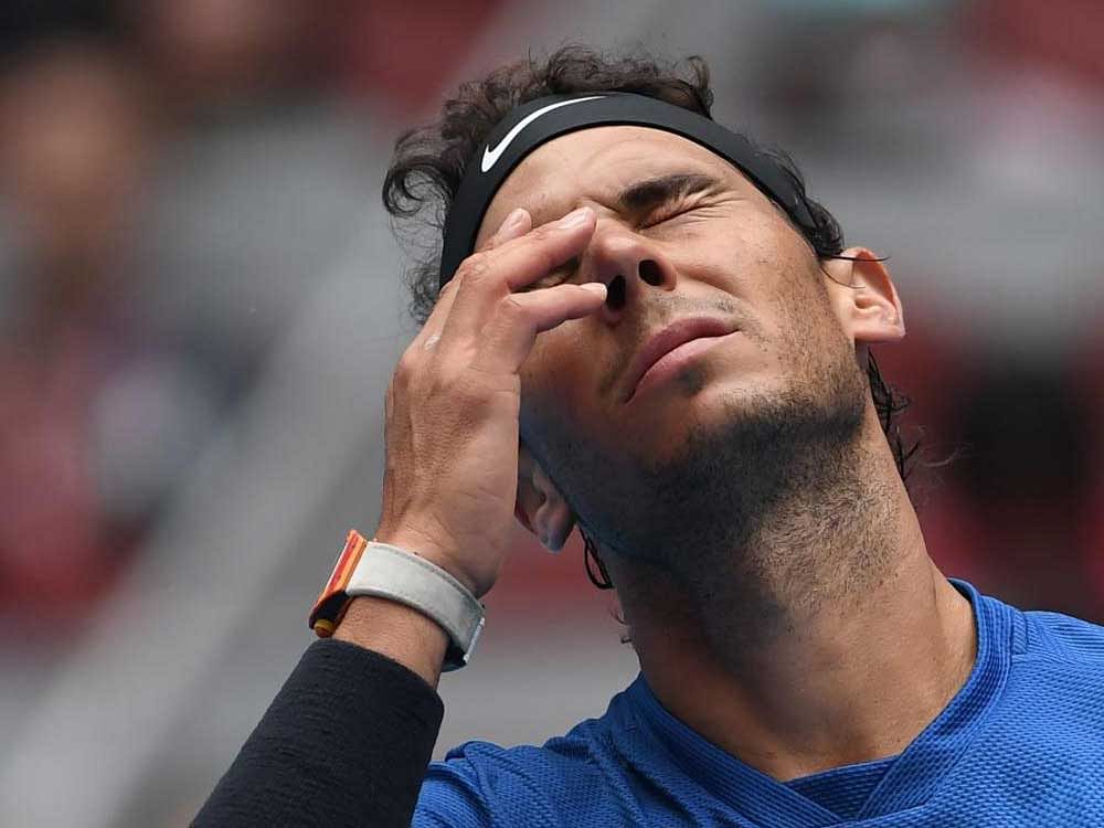 Rafael Nadal clears his eyes after fibre from the ball was lodged in it on Friday.