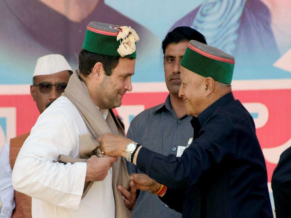 Congress vice president Rahul Gandhi being welcomed by Himachal Pradesh Chief Minister Virbhadra Singh during a rally in Mandi on Saturday. PTI