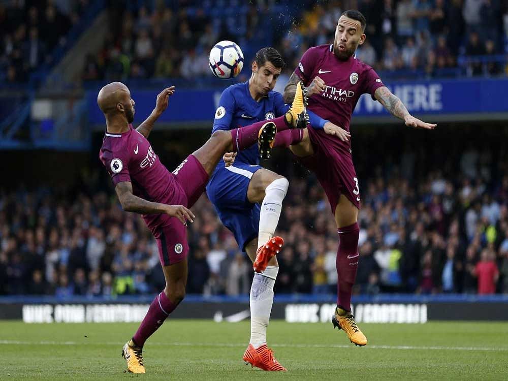 intense: Chelsea's striker Alvaro Morata (centre) vies with Manchester City's Fabian Delph (left) and Manchester City's Nicolas Otamendi. AFP