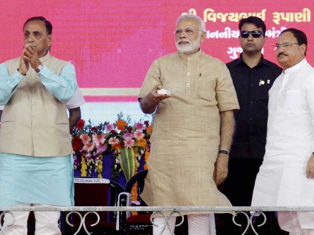 Prime Minister Narendra Modi launches the 'Intensive Indradhanush Misssion' campaign for the vaccination of children at a public meeting in his hometown Vadnagar on Sunday. Union Health Minister J P Nadda and Gujarat CM Vijay Rupani are also seen. PTI