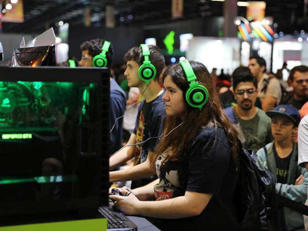 Attendees play demonstration games at the Brasil Game Show. NYT Photo