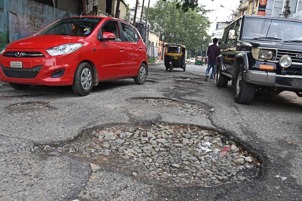 The entire stretch of Residency Cross Road is full of potholes. DH Photo.