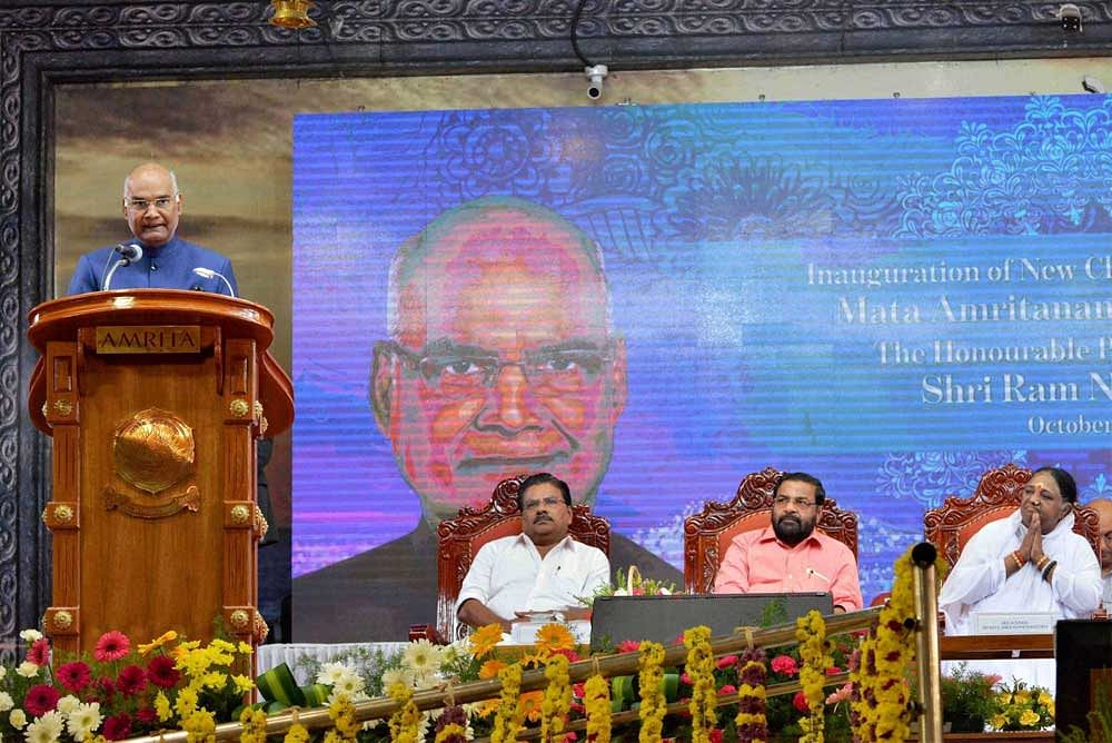 President Ram Nath Kovind speaks at the unveiling of the Amrita Clean Water Initiatives for Rural India at Mata Amritanandamayi Math at Amritapuri, Kerala on Sunday. Amritanandamayi is also seen. PTI Photo
