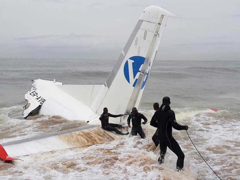 Rescuers pull the wreckage of a propeller-engine cargo plane after it crashed in the sea near the international airport in Ivory Coast's main city, Abidjan, October 14, 2017. REUTERS
