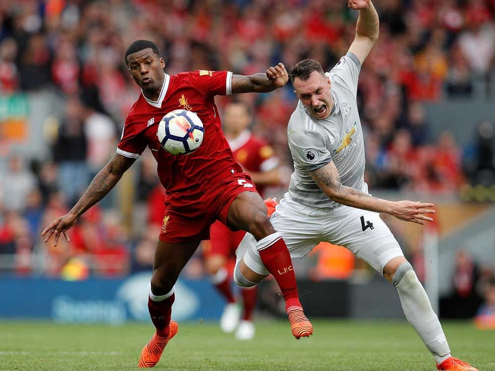 Liverpool's Georginio Wijnaldum in action with Manchester United's Phil Jones. Reuters.
