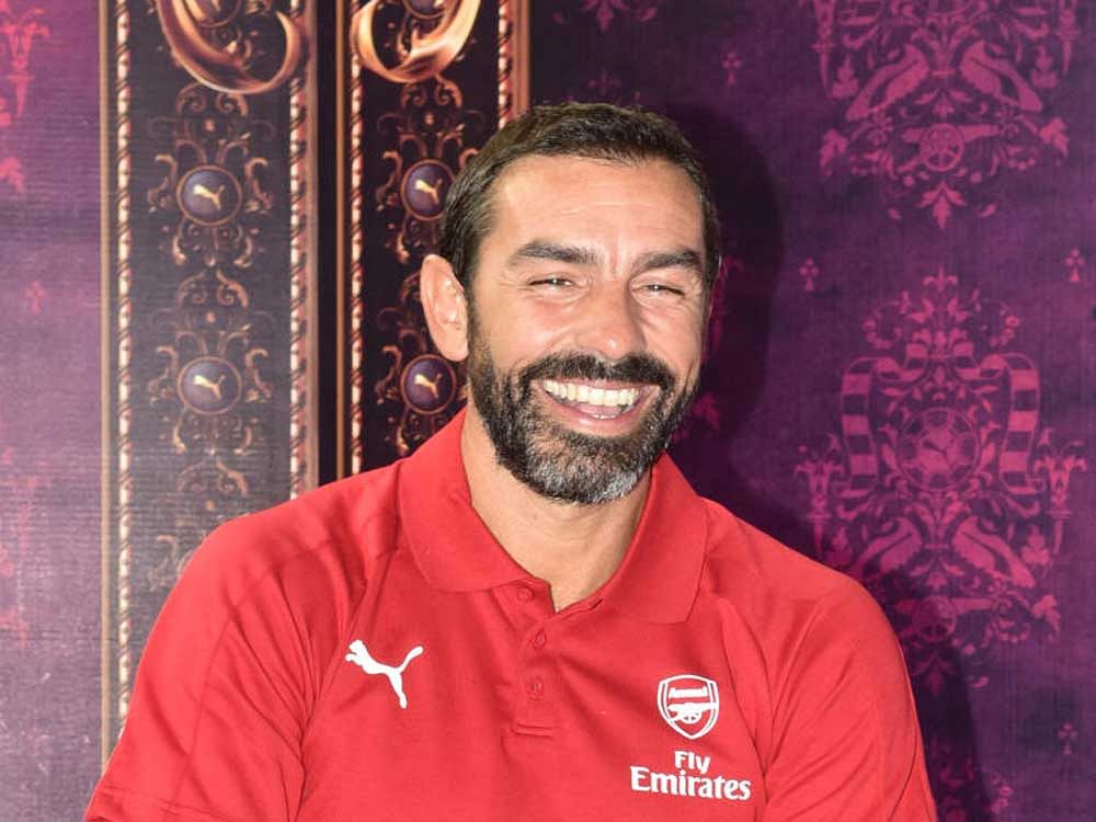 In high spirit: Arsenal legend Robert Pires shares a light moment during a promotional event in Bengaluru on Saturday. DH Photo/ SK Dinesh