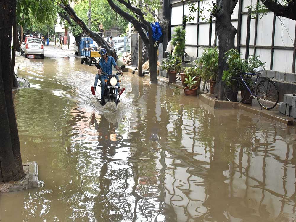 Rain water logged on Kormangala 4th block during heavy rain in Bengaluru on Saturday. DH Photo