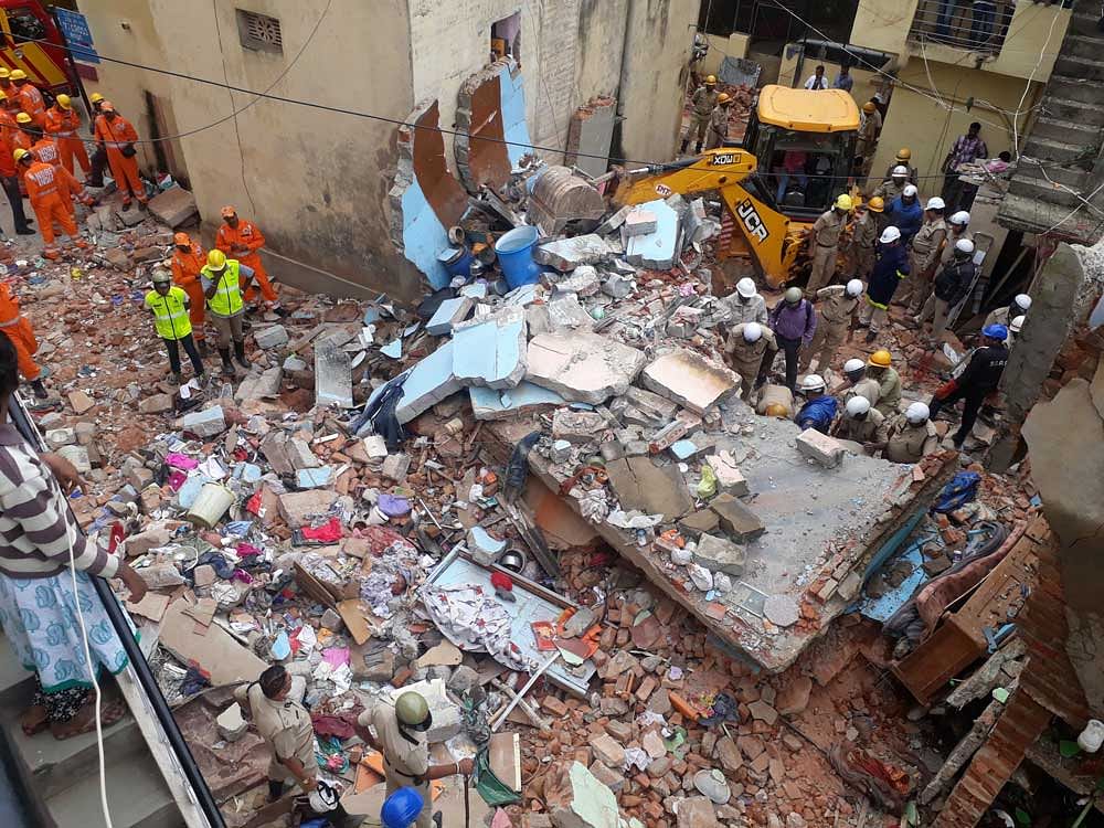 Police and rescue workers clear out debris from a building that collapsed following a cylinder explosion in Ejipura, Bengaluru. ANI photo.