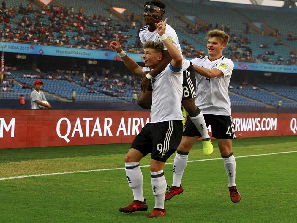 Germany's Jann-Fiete Arp (9) celebrate with teammates after scoring a goal against Columbia during the FIFA U-17 World Cup football match in New Delhi on Monday. Germany won the match by 4-0. PTI Photo