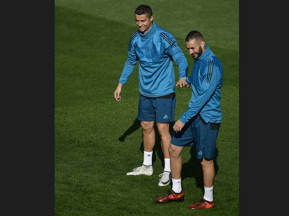 TWO TO TANGO Real Madrid strikers Cristiano Ronaldo (left) Karim Benzema will be keen to punish Tottenham Hotspur when the two sides meet on Tuesday. AFP