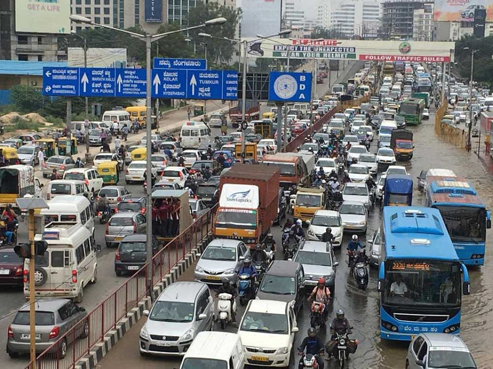 Waterlogged roads, Traffic snarls and potholes are the conditions of the Ecospace service road in Outer Ring Road (ORR). DH Photo