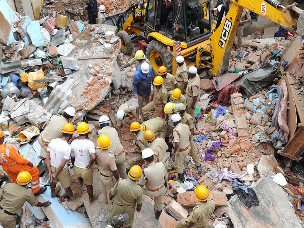 Fire personnal searcjhing for bodies of Aswini and Saravanan in the building collesped due to gas cylinder blast at Gundappa Gowda Layout of Egipura in Bengaluru on Monday. Photo Srikanta Sharma R.