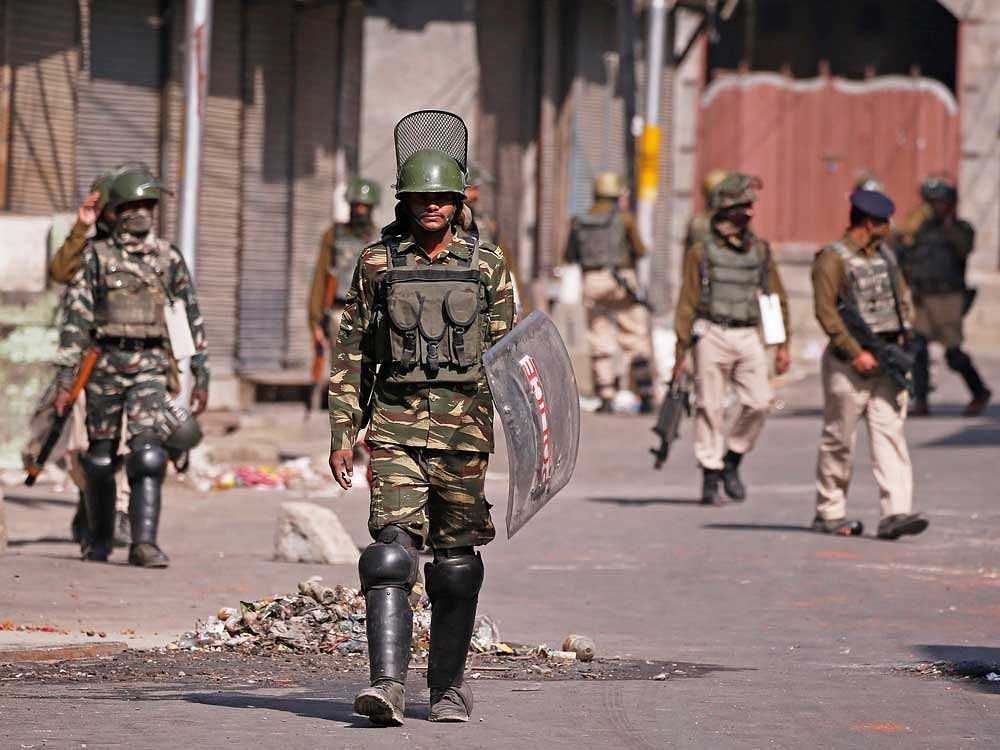 Indian policemen patrol Maisuma area during a curfew in Srinagar. Reuters photo