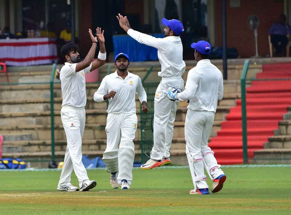Karnataka captain Vinay Kumar celebrates with team-mates the dismissel of Abu Nechim Ahmed of Assam in Mysuru on Tuesday. DH PHOTO / IRSHAD MAHAMMAD