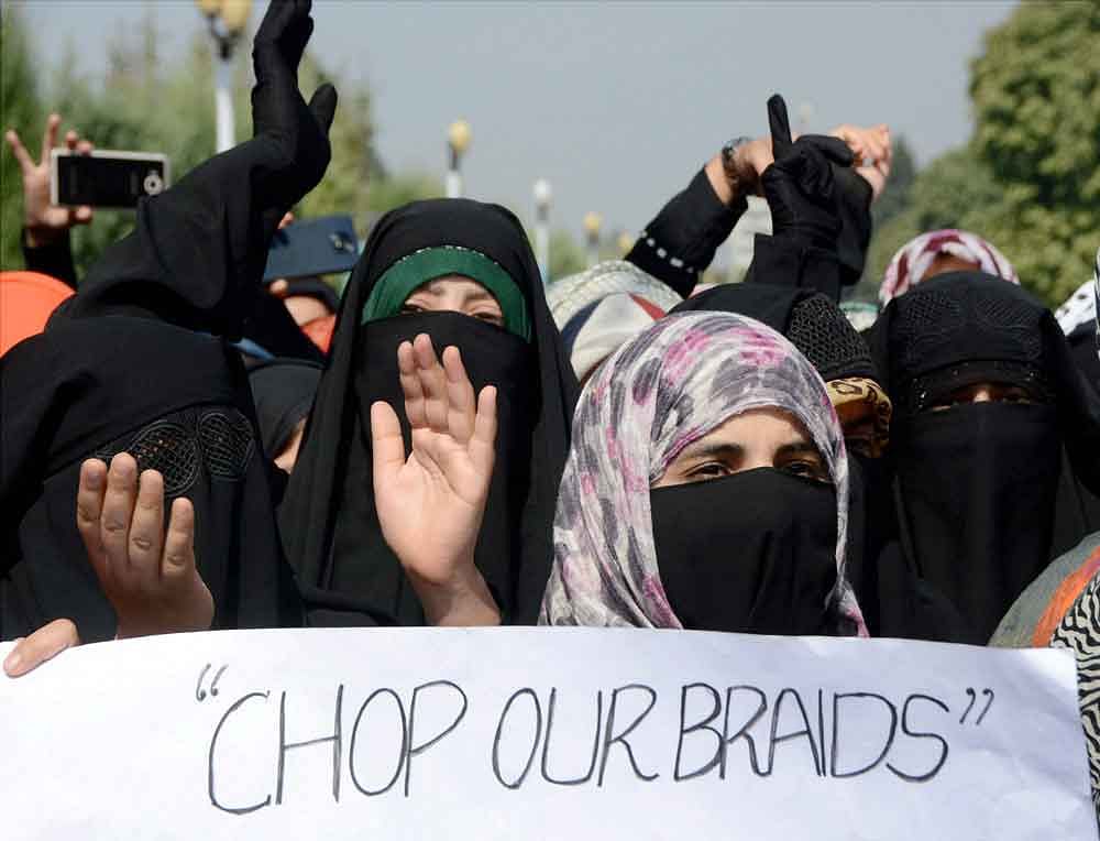 Students shout slogans during a protest rally against the fresh incidents of braid chopping in the Valley, at Kashmir University in Srinagar on Thursday. PTI Photo