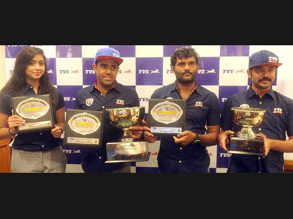 Champions (From left) Winners of Raid de Himalaya Aishwarya Pissay (Ladies class), Abdul Wahid Tanveer (Group A), Rajendra (Group B) with Selvaraj (manager) of TVS Racing in Bengaluru on Tuesday.
