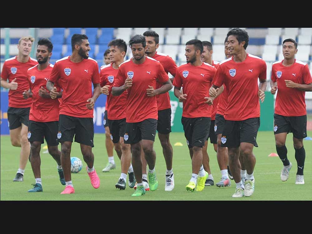 Getting ready: Bengaluru FC players warm-up on the eve of their AFC Cup tie on Tuesday. DH Photo/ Srikanta Sharma R