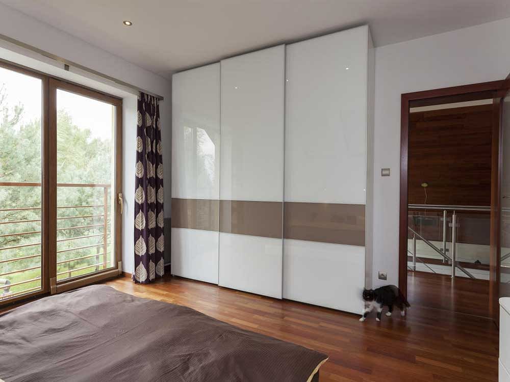 Contemporary bedroom with balcony and huge wardrobe glass