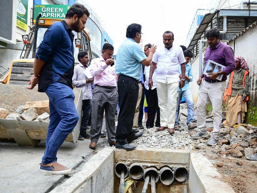 Mayor R Sampath Raj inspects the ongoing repair of Church Street. The BBMP's chief project engineer, K T Nagaraj, and others officials were also present. DH PHOTO